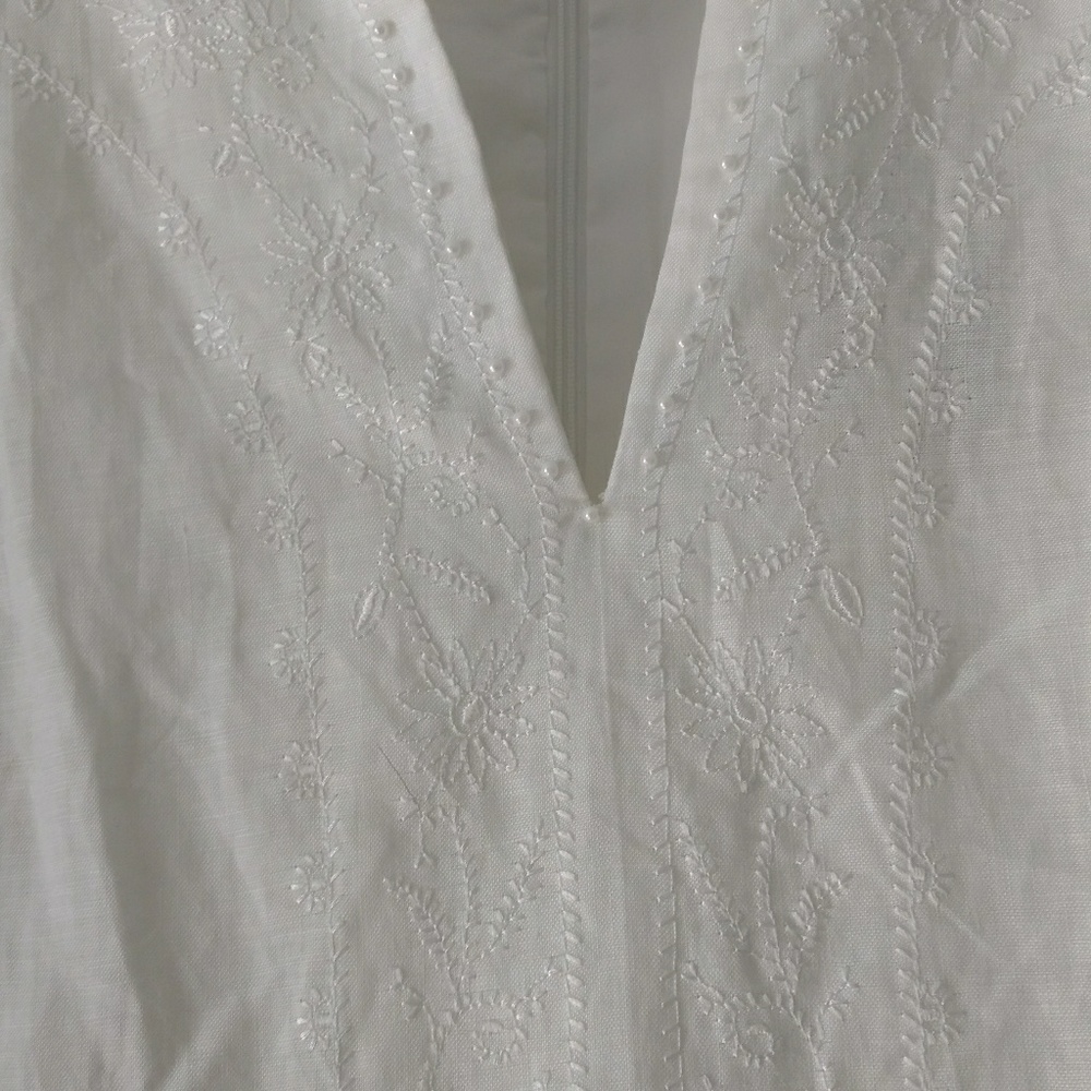Ladies white dress with embedded detail.